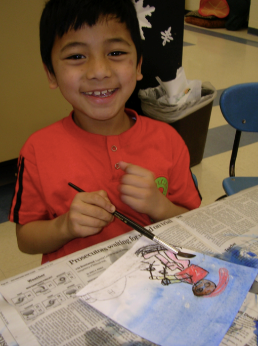 Student painting a skier in the Winter Stories process